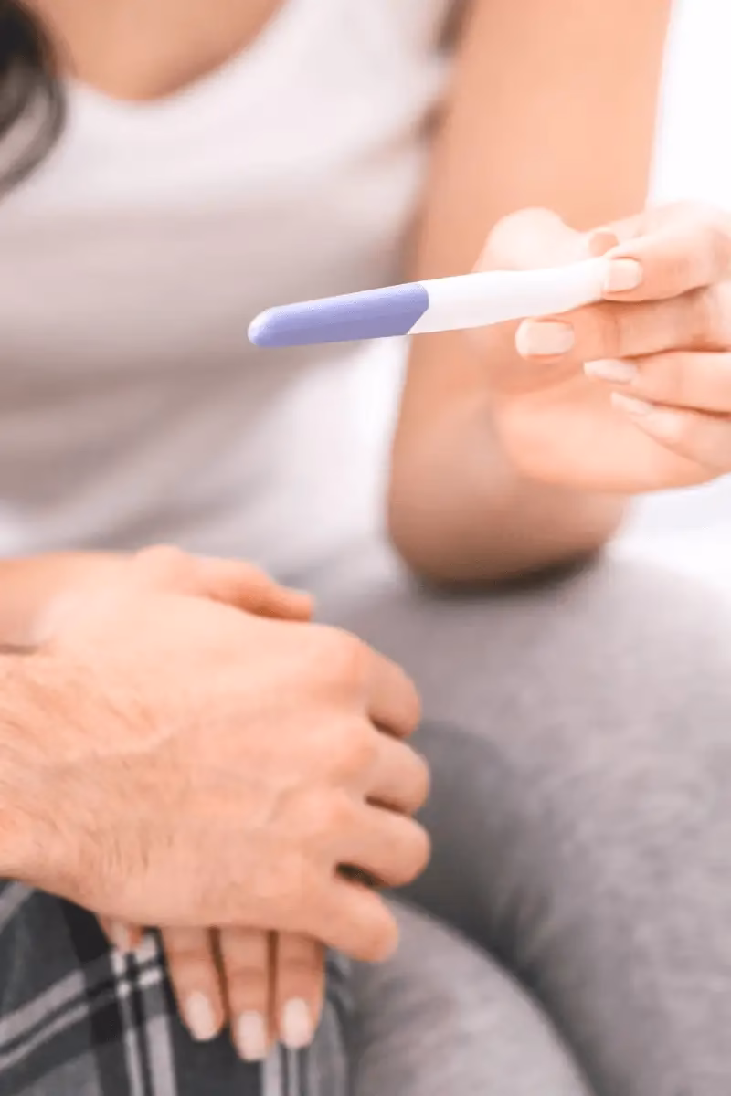 A woman holding a pregnancy-test